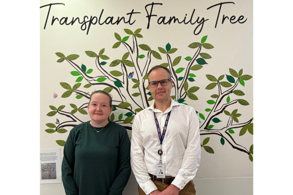 Liver-intestinal transplant patient Clare with Professor Adam Testro, Director of Liver and Intestinal Transplant Medicine, in front of the Transplant Family Tree on Ward 8 West.